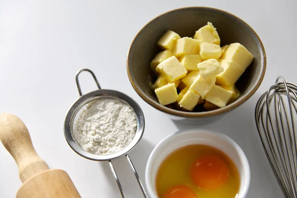 Rolling pin, butter, eggs, flour and whisk — Stock Photo, Image