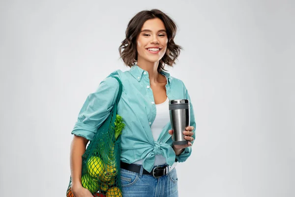 happy smiling woman with food in reusable net bag