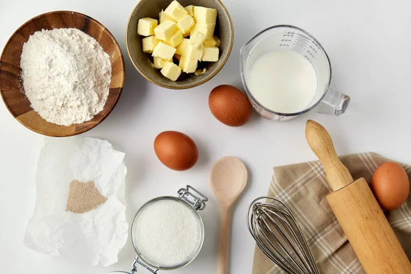 Rolling pin, butter, eggs, flour, milk and sugar — Stock Photo, Image