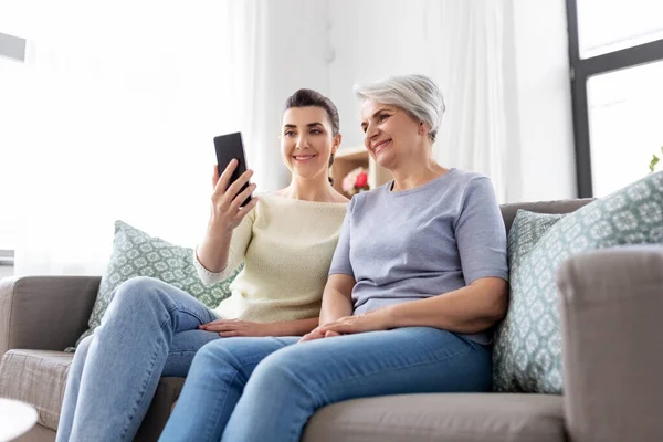 Senior moeder met dochter nemen selfie thuis — Stockfoto