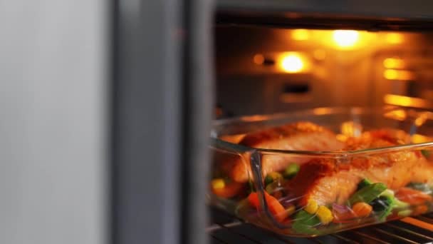 Cocina de alimentos en bandeja de horno en casa — Vídeo de stock