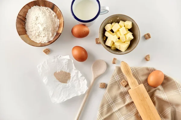 Rolling pin, butter, eggs, flour, milk and sugar — Stock Photo, Image