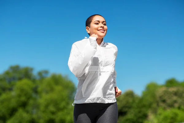 African american woman running outdoors — Stock Photo, Image