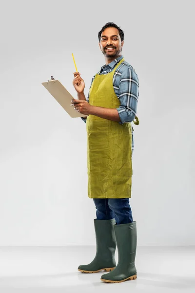 Happy indian gardener or farmer with clipboard — Stock Photo, Image