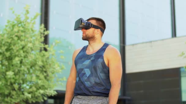 Happy young man with vr glasses outdoors — Stock Video