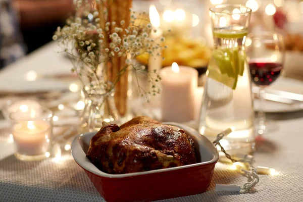 Roast chicken on served table at home dinner party — Stock Photo, Image