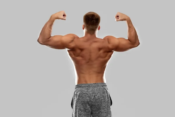 Young man or bodybuilder with bare torso — Stock Photo, Image