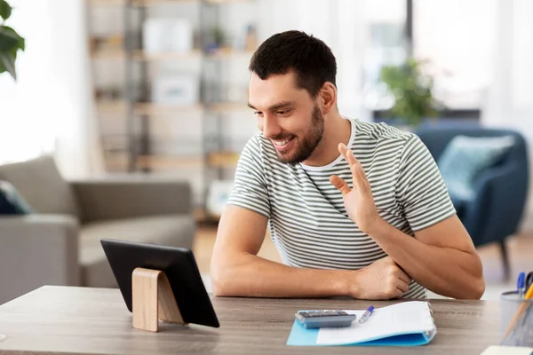 Man with tablet pc having video call at home — Stock Photo, Image