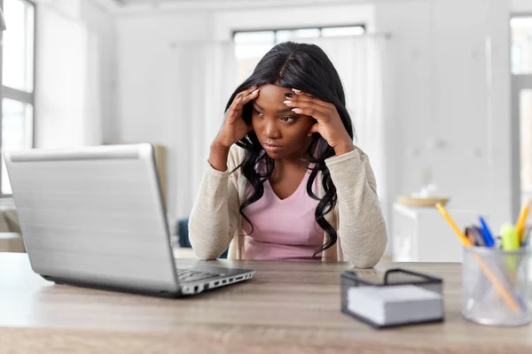 Напряженная женщина с ноутбуком работает в домашнем офисе — стоковое фото