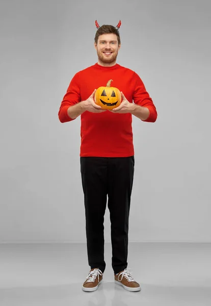 Happy man in halloween costume of devil over grey — Stock Photo, Image