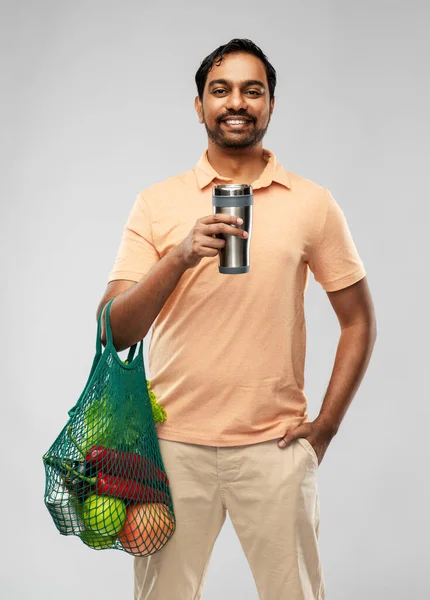 Man with food in bag and tumbler or thermo cup — Stock Photo, Image