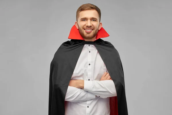 happy man in halloween costume of vampire