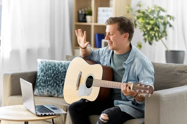 Man with laptop and guitar having video call — Stock Photo, Image