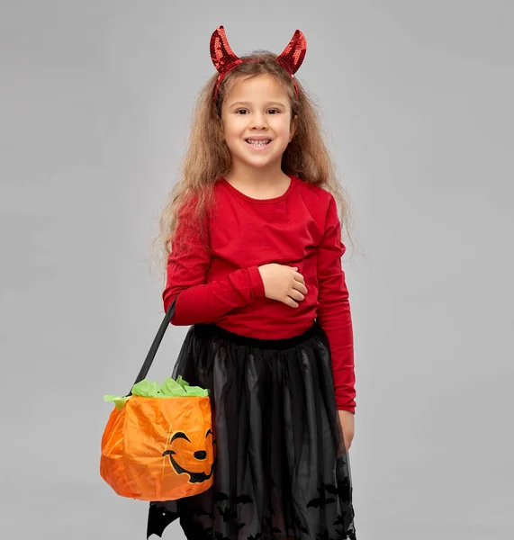 Girl with horns trick-or-treating on halloween — Stock Photo, Image