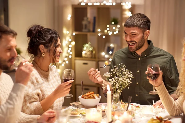 Happy friends having christmas dinner at home — Stock Photo, Image