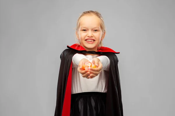 Girl in halloween costume of dracula with candies — Stock Photo, Image