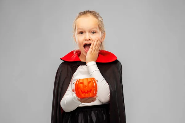 Girl in halloween costume of dracula with pumpkin — Stock Photo, Image