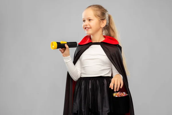 Girl in halloween costume of dracula with candies — Stock Photo, Image