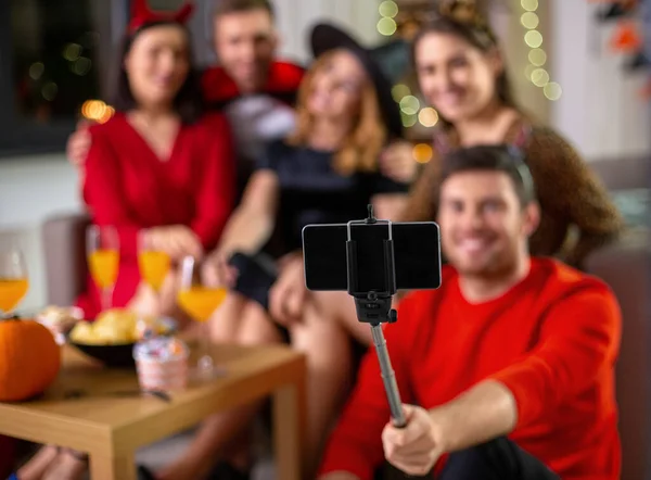 Happy friends in halloween costumes taking selfie — Stock Photo, Image