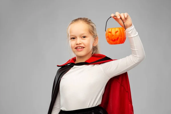 Girl in halloween costume of dracula with pumpkin — Stock Photo, Image