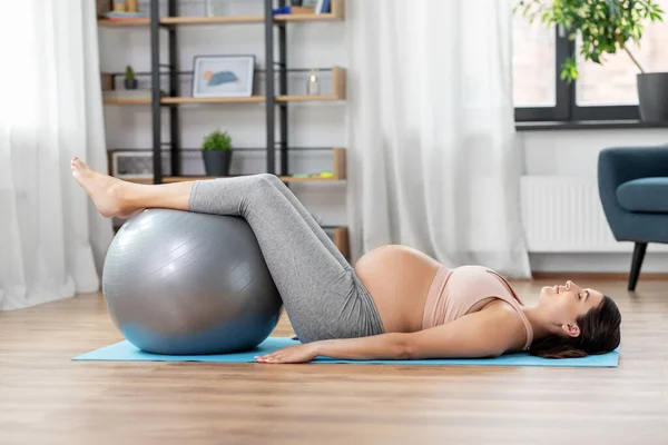 Pregnant woman training with fitness ball at home — Stock Photo, Image