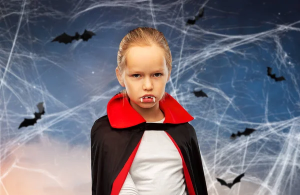 Girl in dracula costume with cape on halloween — Stock Photo, Image