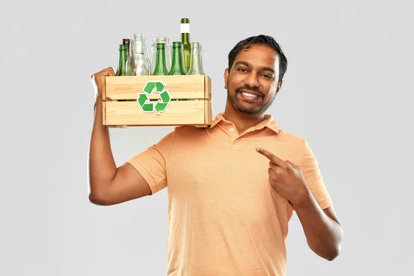 Smiling young indian man sorting glass waste — Stock Photo, Image