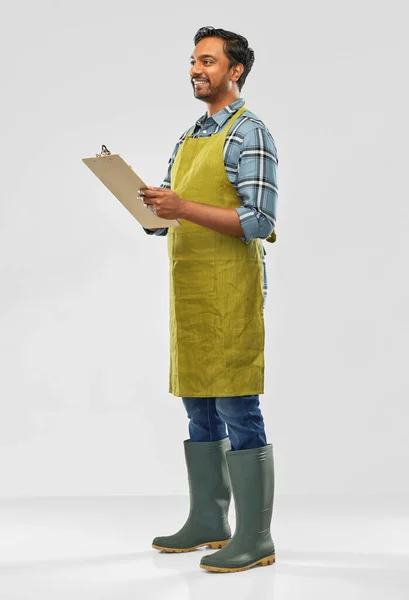 Happy indian gardener or farmer with clipboard — Stock Photo, Image