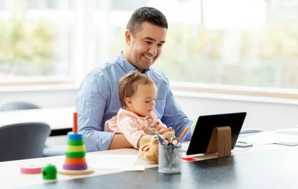 Vader met baby werken op tablet pc thuis — Stockfoto
