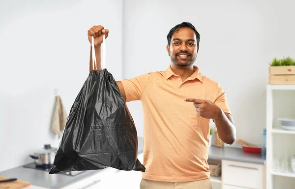 Smiling indian man holding trash bag — Stock Photo, Image