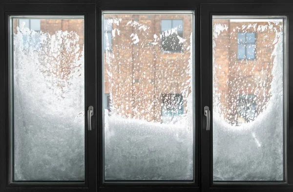 window glass covered with snow in winter