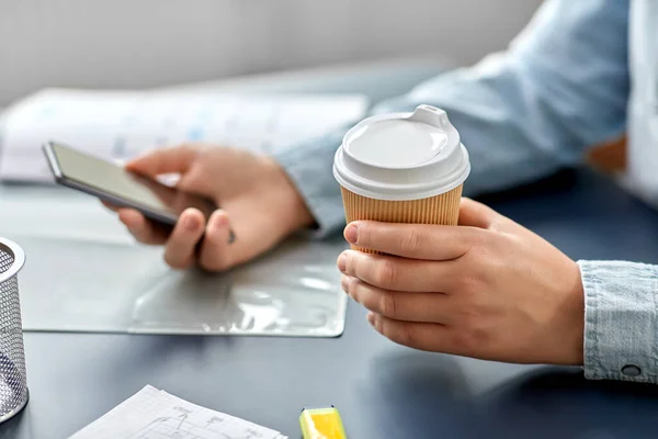Mujer con café usando smartphone en la oficina —  Fotos de Stock