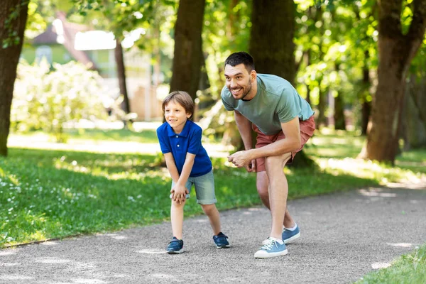 Pai feliz e filho competir na corrida no parque — Fotografia de Stock