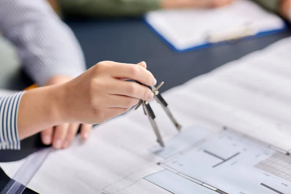 Architect with blueprint and drafting compass — Stock Photo, Image