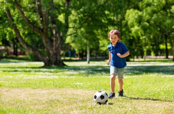 Happy little boy with ball playing soccer at park — Stock Photo, Image