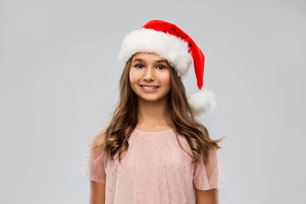 Feliz adolescente en sombrero de santa en Navidad —  Fotos de Stock