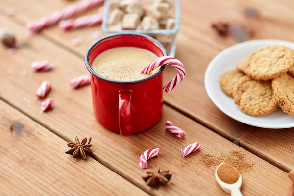 Cup of eggnog with candy cane, cookies and sugar — Stock Photo, Image