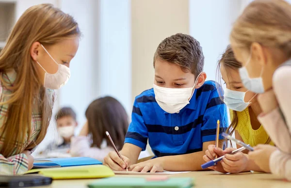 Group of students in masks learning at school — Stock Photo, Image