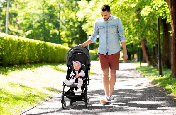 Lycklig far med barn i barnvagn på sommarparken — Stockfoto