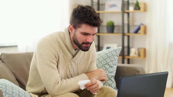 Sick man having video call on laptop at home — Stock Video