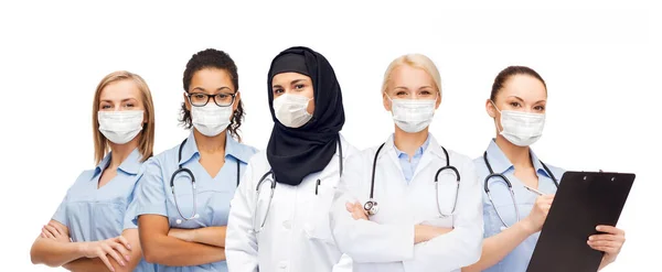 Group of female doctors in masks with stethoscopes — Stock Photo, Image