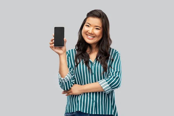 Happy asian woman over grey background — Stock Photo, Image