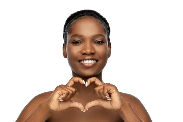 Χαμογελαστή Αφροαμερικανή που δείχνει την καρδιά της. Royalty Free Εικόνες Αρχείου