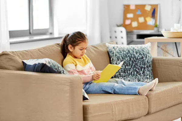 Bambina lettura libro a casa — Foto Stock