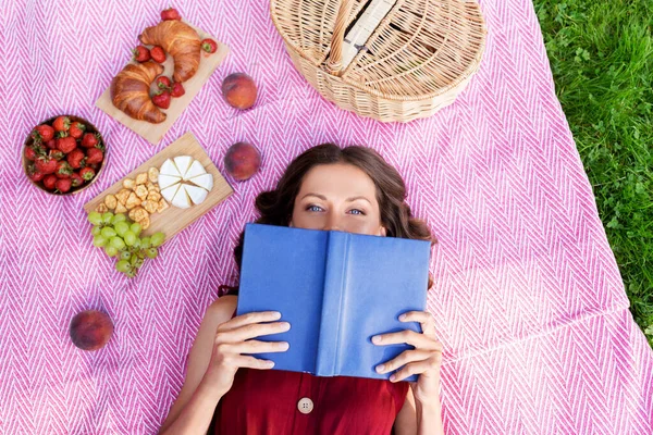 Szczęśliwa kobieta czytanie książki na pikniku w parku letnim — Zdjęcie stockowe