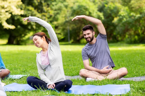 Group of people exercising at summer park — Stock Photo, Image