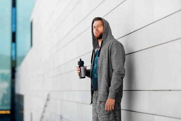 Sportsman with bottle of water in city — Stock Photo, Image