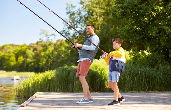 Happy smiling father and son fishing on river — Stock Photo, Image