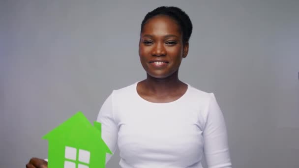 Sorridente afro-americano mulher segurando casa verde — Vídeo de Stock