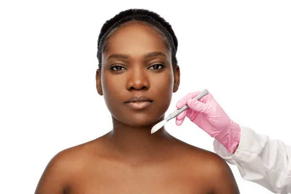 Gesicht einer afrikanisch-amerikanischen Frau und Skalpellmesser — Stockfoto